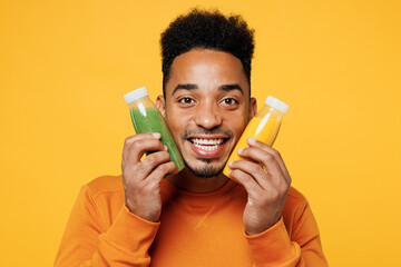 Close up young man he wear casual clothes hold show fruit juice green vegetable smoothie as detox...