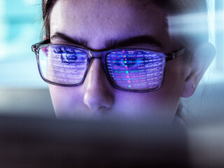 Businesswoman examining stock exchange data on computer