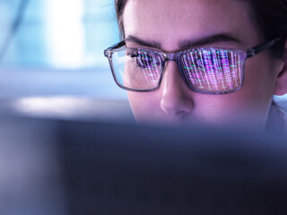 Young scientist examining DNA data on computer