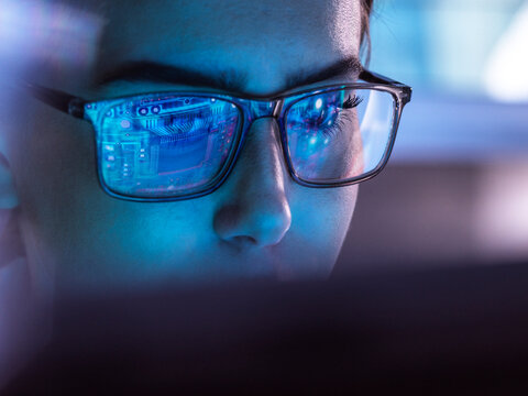 IT professional wearing eyeglasses and working on computer