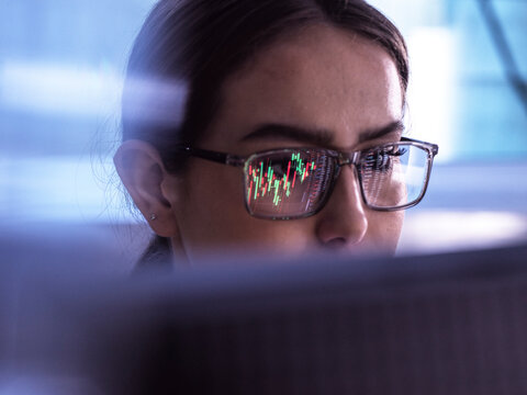 Businesswoman examining investment chart on computer