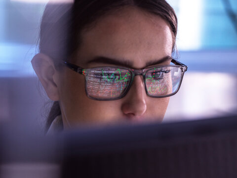 Trader analyzing financial market data on computer