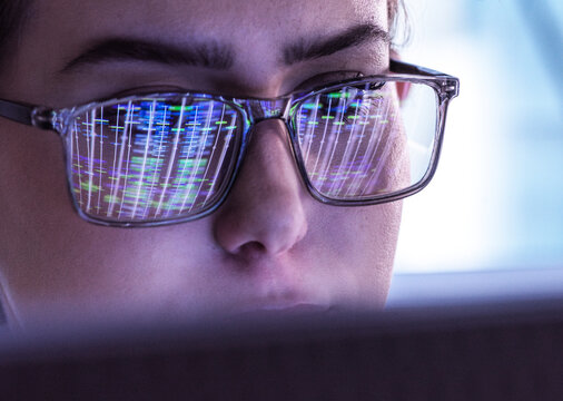 Scientist wearing eyeglasses and analyzing DNA data on computer