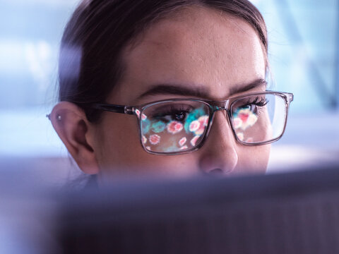 Scientist examining virus particles through electron micrograph on computer