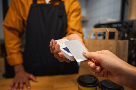 Customer paying with credit card at cafe