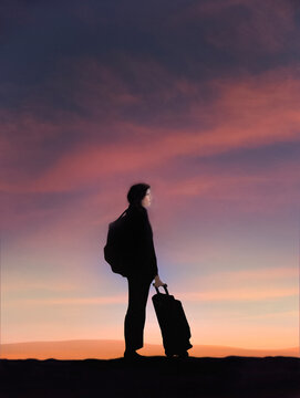 Young woman traveling with luggage at sunset