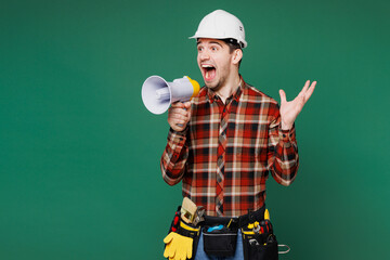 Young employee laborer handyman man wear red shirt hardhat hat work scream in megaphone isolated on...