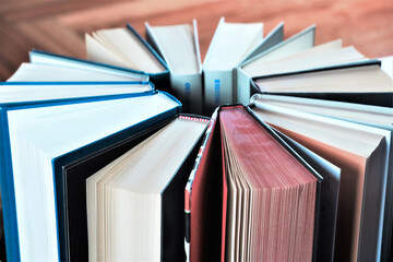 stack of books, close up. Open book on the table in library. Back to school concept. Open book on...
