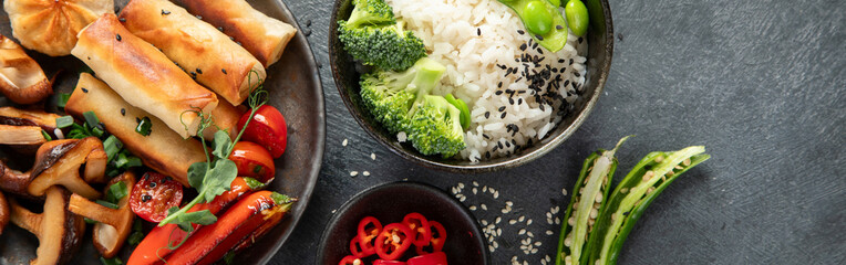 Homemade sesame Chicken served with white rice and vegetables. Asian food dishes.
