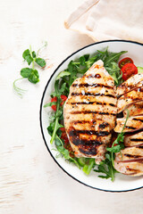 Roasted chicken breast, fillet and fresh vegetable salad.