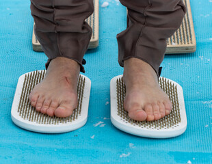 walking bare feet on metal nails.