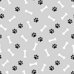 Black domestic pet's paws prints and white bones on gray background. Vector seamless pattern.