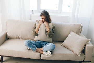 Distressed Woman Resting on Couch, Feeling Sad and Worried, Expressing Mental Health Pain at Home