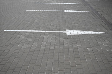 white arrow on gray asphalt, turn left, turn right, abstract white lines on asphalt, background of...