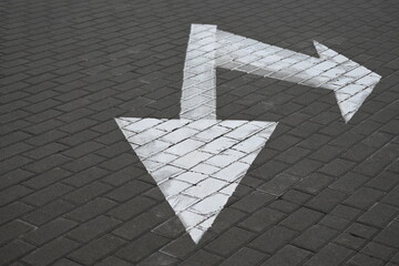 white arrow on gray asphalt, turn left, turn right, abstract white lines on asphalt, background of...