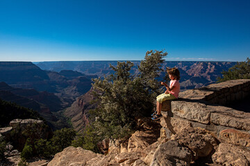 Kid on Grand Canyon. Child enjoy mountain in National Park.