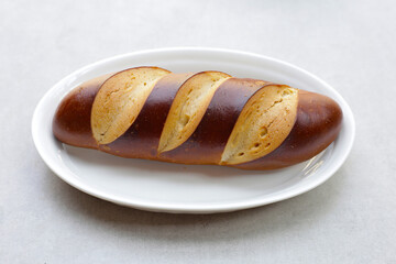 Plain Laugen bread on grey background.