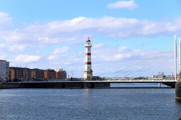 MALMO, SWEDEN. August 16, 2023 View on the Malmö Inre fyr old lighthouse in the city of Malmo, Sweden. Some buildings on the side. A small canal in front of the lighthouse. - obrazy, fototapety, plakaty