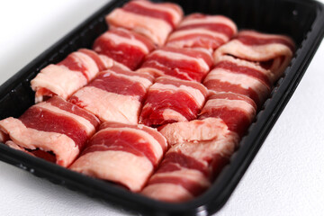 Sliced raw beef isolated on a white background