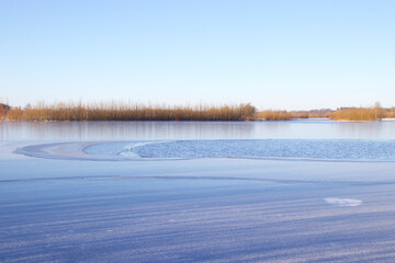 Ice and open water on the lake before it all will be frosen