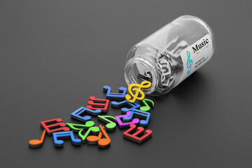 Musical notes spill out of a medicine bottle