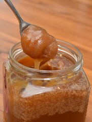 teaspoon and glass jar with honey