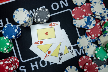 poker chips with win combination four aces cards  at casino table