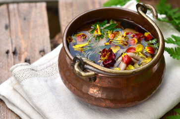 Dyeing of fabric with natural dyes, fabric in a copper vat with plants, marigolds, linen, environmental friendliness.
