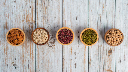 Mung beans, Red kidney beans, Chickpeas source and peeled barley in a basket wooden isolated on wood background