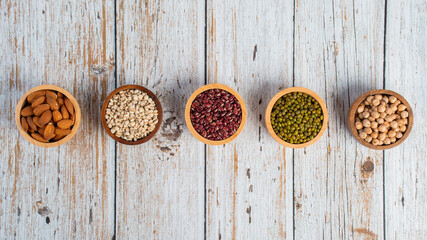Mung beans, Red kidney beans, Chickpeas source and peeled barley in a basket wooden isolated on wood background