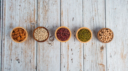 Mung beans, Red kidney beans, Chickpeas source and peeled barley in a basket wooden isolated on wood background