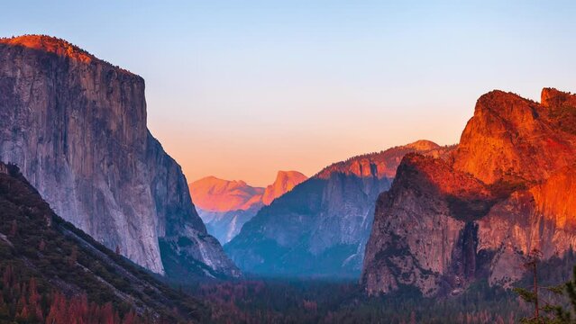 Yosemite National Park Tunnel View overlook at sunset. Front view panorama of popular El Capitan and Half Dome at deep red sunset. Summer american holidays. California, United States.