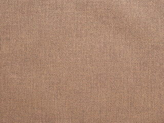 Abstract beige textured canvas background or backdrop.