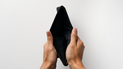 Hands of man holding empty wallet. end of month concept