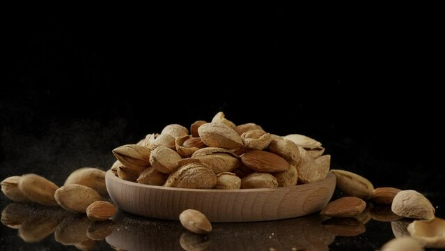 almonds，organic badam falling on table.