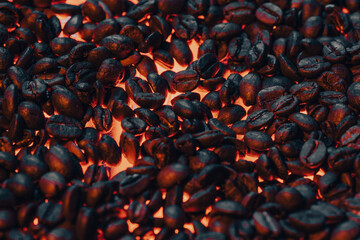 Roasted coffee beans with smoke and fire background. Close up,
