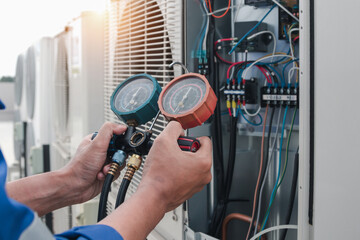 Technician is checking air conditioner,measuring equipment for filling air conditioners.