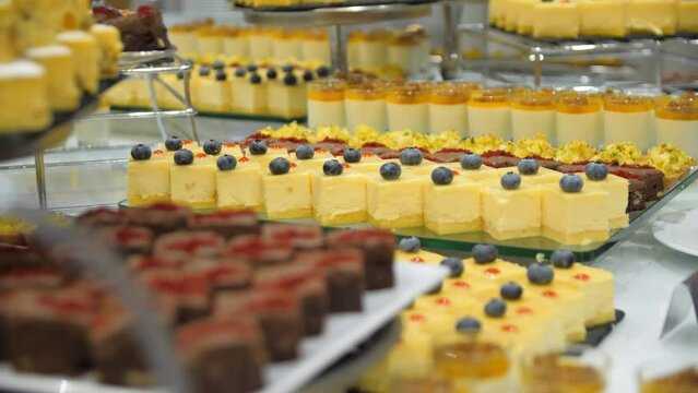 Close-up of a buffet table with cakes in a restaurant. Beautifully presented banquet table with sweet dishes. A dessert table.