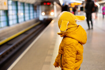 Cute preschool child, boy, standing on a platform in metro, waiting for the subway