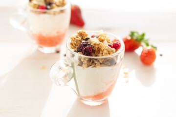 Yogurt with red fruit granola with strawberry cream, almonds and chocolate chips. Healthy snack idea for children.