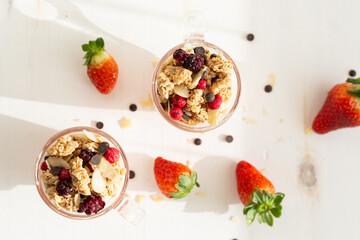 Yogurt with red fruit granola with strawberry cream, almonds and chocolate chips. Healthy snack idea for children.