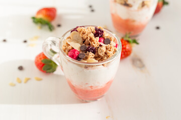 Yogurt with red fruit granola with strawberry cream, almonds and chocolate chips. Healthy snack idea for children.