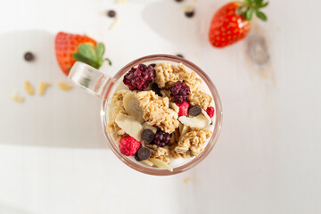 Yogurt with red fruit granola with strawberry cream, almonds and chocolate chips. Healthy snack idea for children.