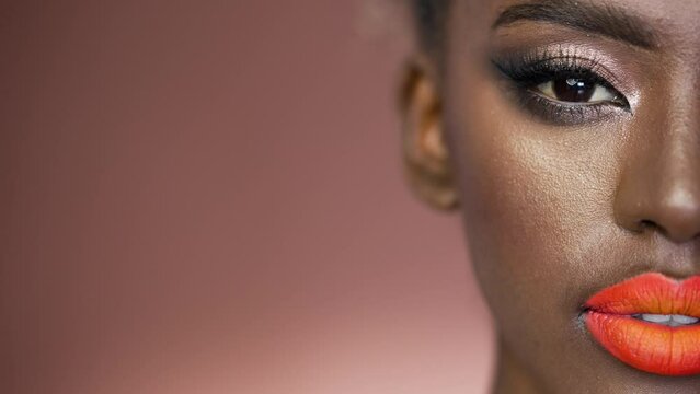 Half face of beautiful black African American woman wearing fashion make up