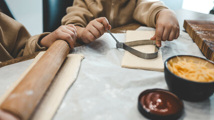 Children making pizza in the kitchen