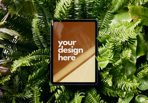 Mockup of digital tablet with customizable screen in foliage