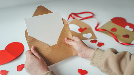 Valentine's Day, a note in a paper heart envelope. Top view. Copy space. Place for text