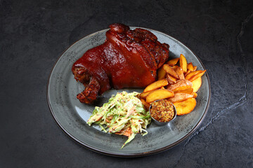 Baked pork knuckle with vegetables. Cabbage salad. Homemade grilled potatoes. A traditional beer snack.