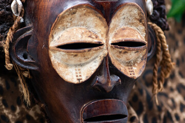 Wooden tribal African mask from Uganda, for family or personal protection, made of local wood, ropes and seashells as hair decoration