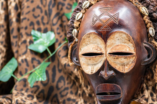 Wooden tribal African mask from Uganda, for family or personal protection, made of local wood, ropes and seashells as hair decoration
